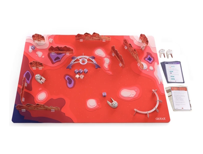 A replica of the Mars surface as a red board game setup with small toy pieces, dice shaped resources, and numbered cards with activities