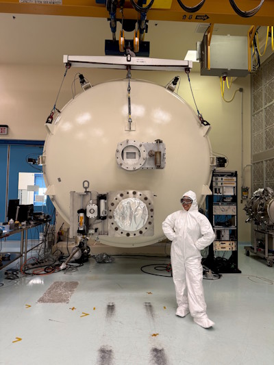 Zoefia Mojica dressed in a bunny suit in the Stray Light Test Facility cleanroom at NASA Marshall Space Flight Center